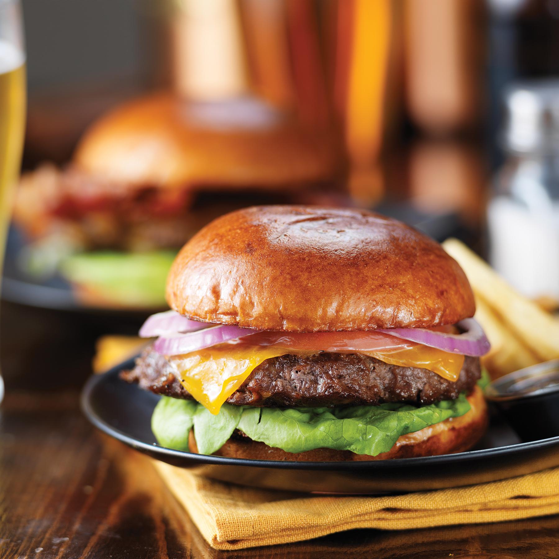 cheeseburgers and fries on table top