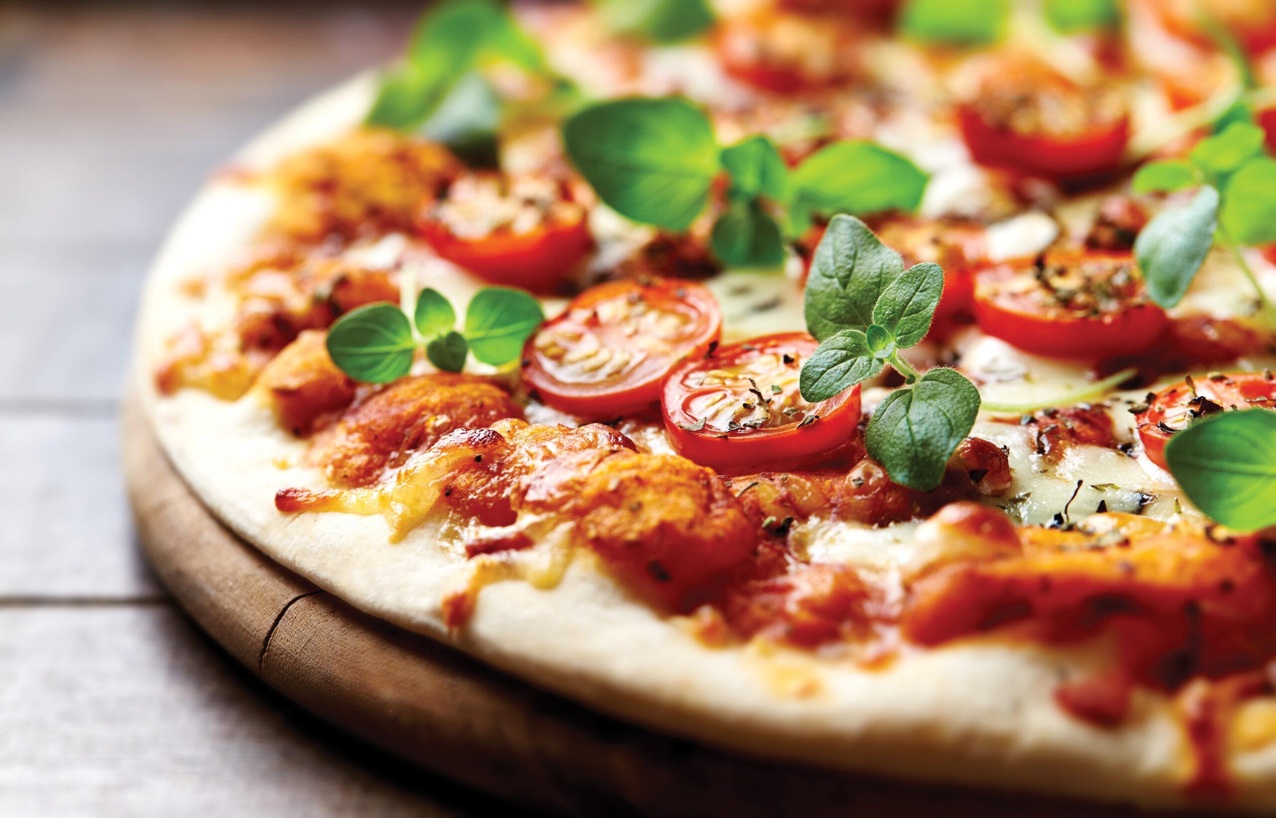 Tasty vegetarian pizza with cherry tomatoes, mozzarella cheese and basil