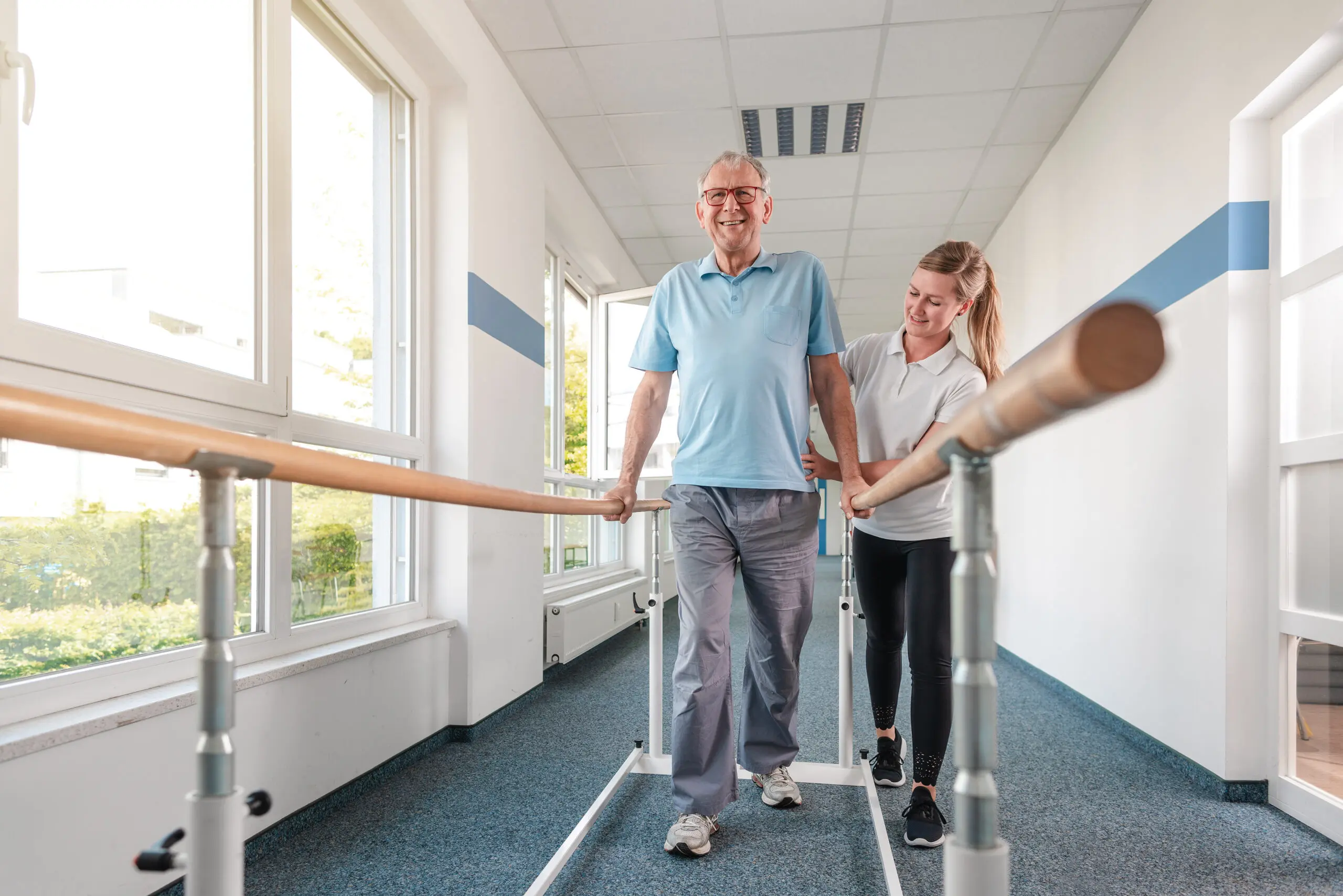 Senior Patient and physical therapist in rehabilitation walking exercises